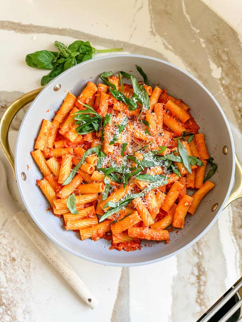 Cottage cheese vodka sauce pasta with smooth pink cream sauce halal ground beef rigatoni Parmesan and fresh basil in a wide bowl