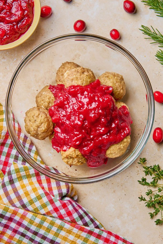 cranberry glaze poured over meatballs