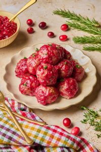 meatballs on a plate coated in the cranberry glaze