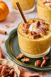 pumpkin overnight oats in a container with pecans on top