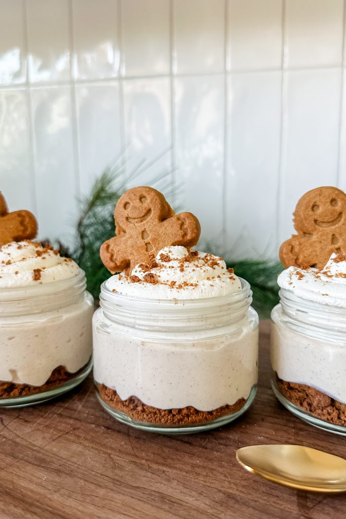 gingerbread cottage cheesecake jars lined up on a counter top