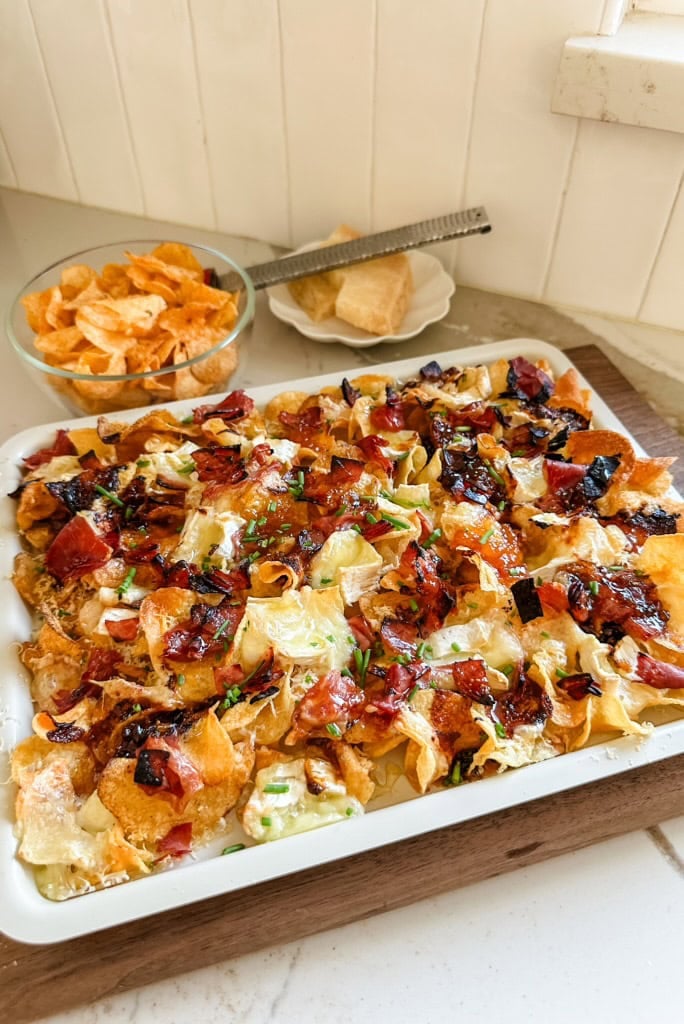 charcuterie nachos baked on a baking sheet