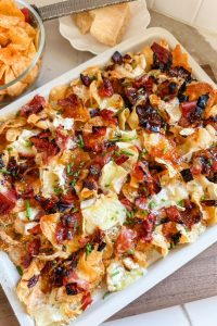 dill pick charcuterie nachos on a sheet pan