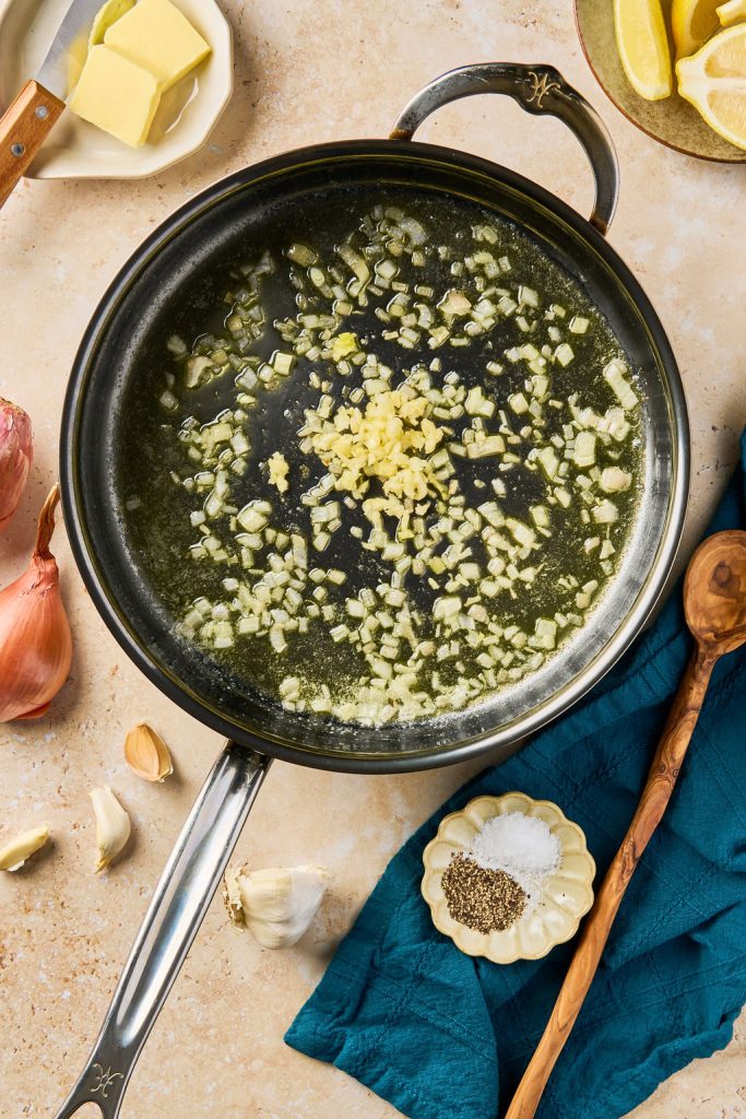 garlic added to the cooked shallots in a skillet