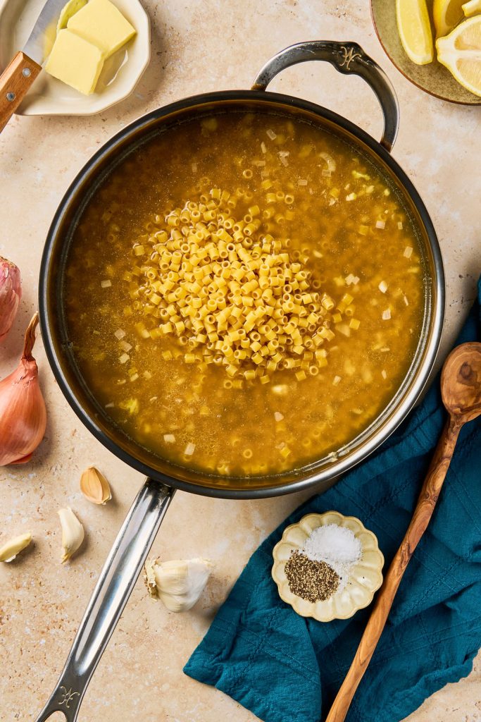 pasta and bone broth added to the skillet