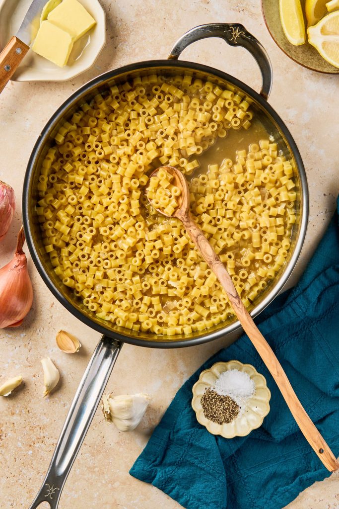cooked pasta in a skillet with a spoon