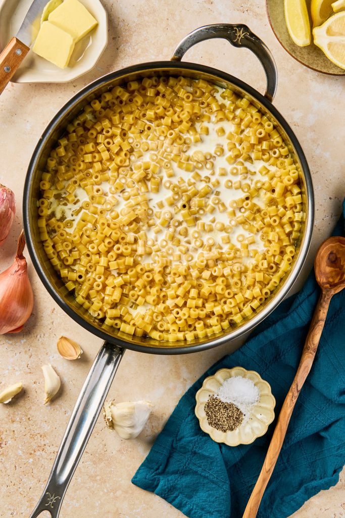 heavy cream added to the cooked pasta in a skillet