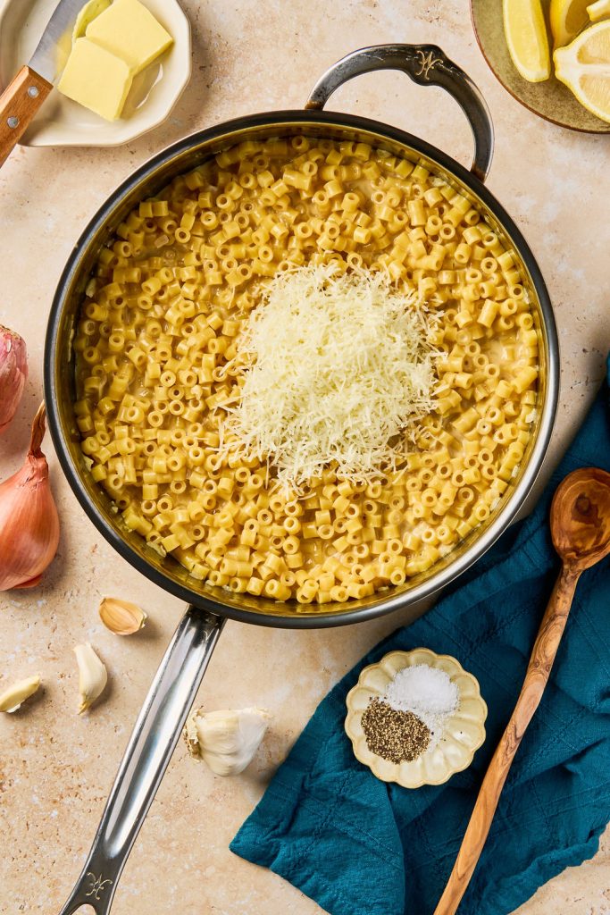 Parmesan cheese added to pasta in the skillet