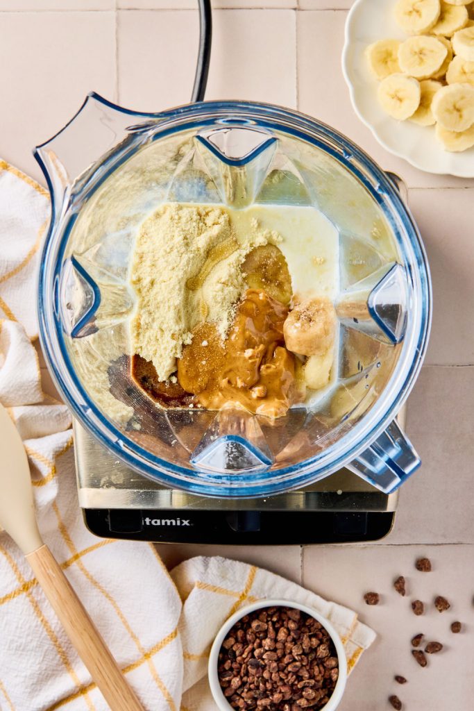 all the ingredients for a peanut butter smoothie in a blender