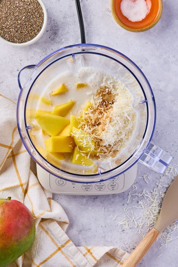 milk, mango, shredded coconut, maple syrup, vanilla, and a pinch of salt in a blender
