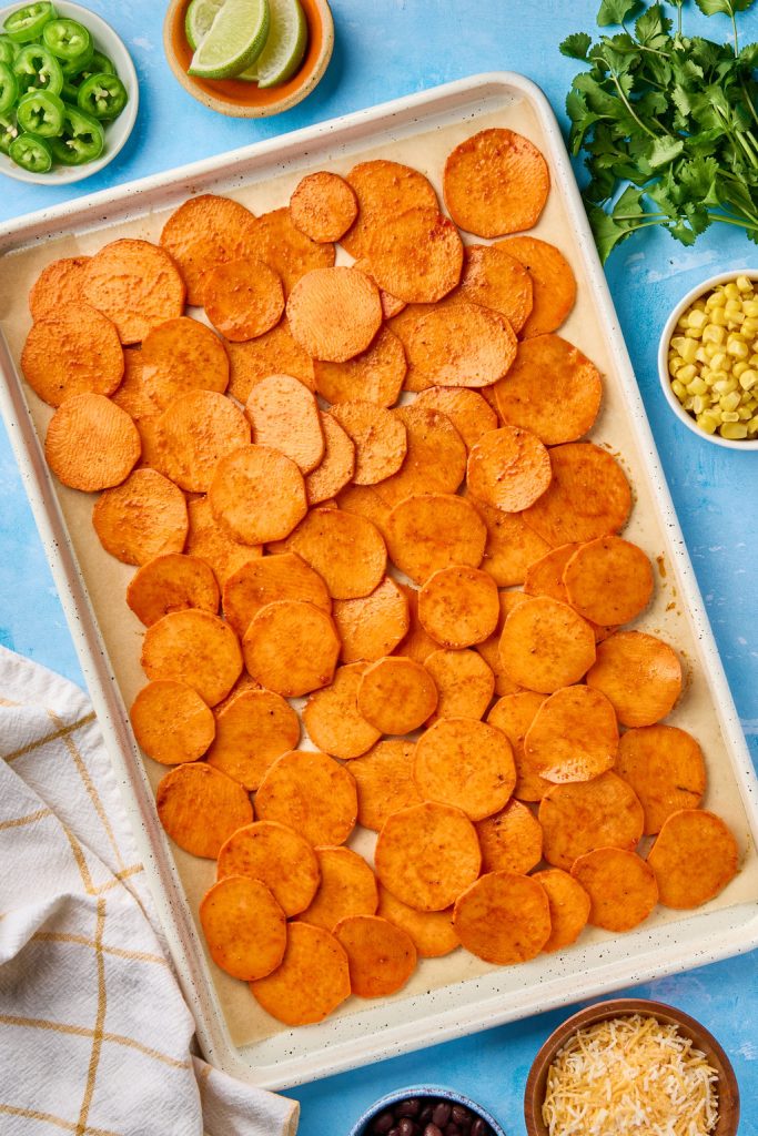 sweet potato rounds laid out on a baking sheet
