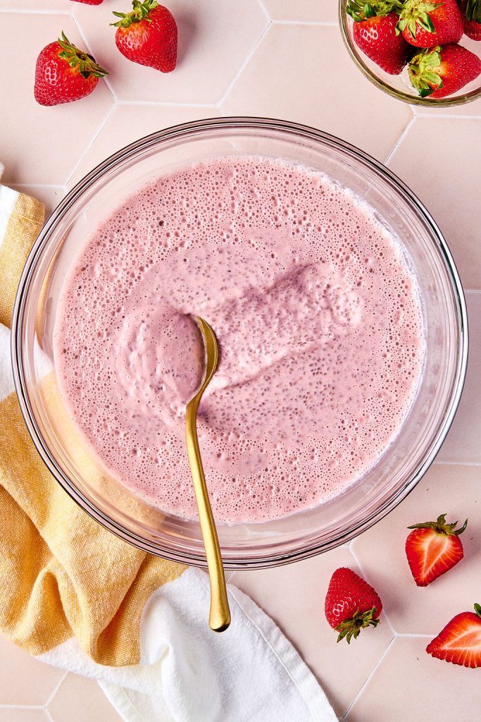 a spoon scooping the chia pudding to show the thick consistency