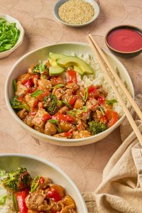 pineapple teriyaki chicken rice bowl with avocado and chopsticks