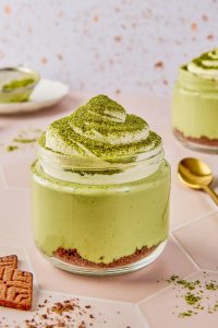 unclose of matcha cottage cheesecake jar with matcha powder on top