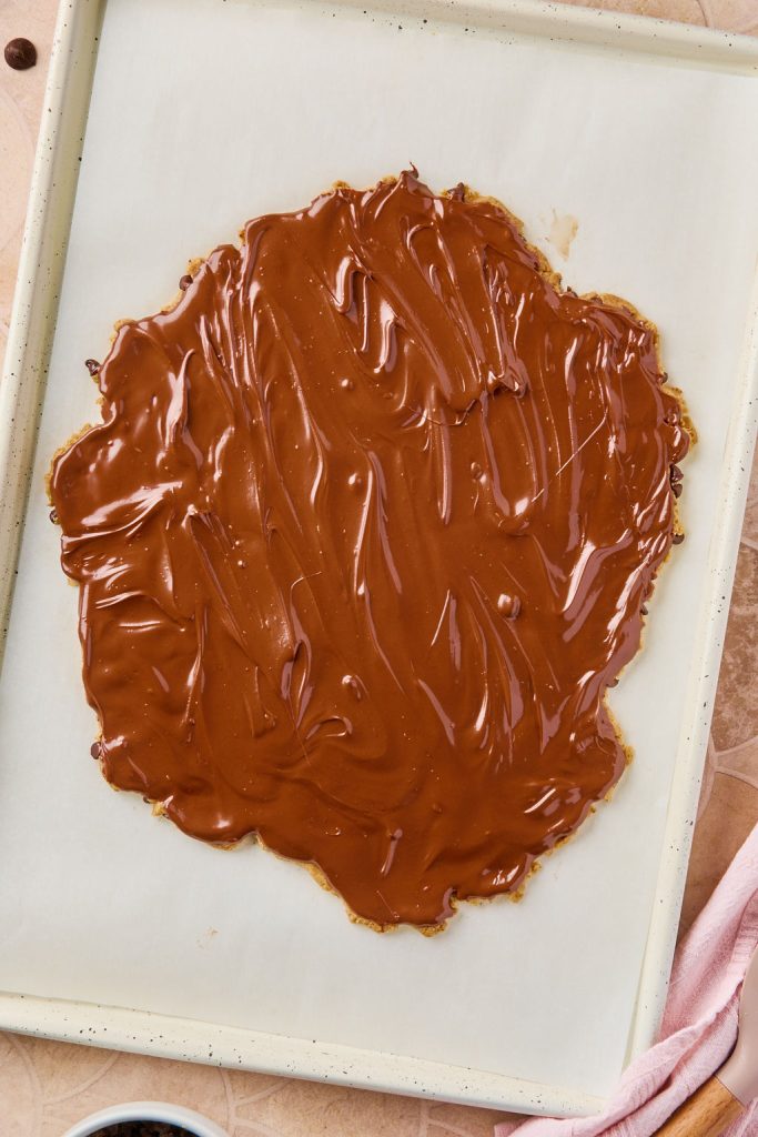 melted chocolate spread evenly over cookie dough