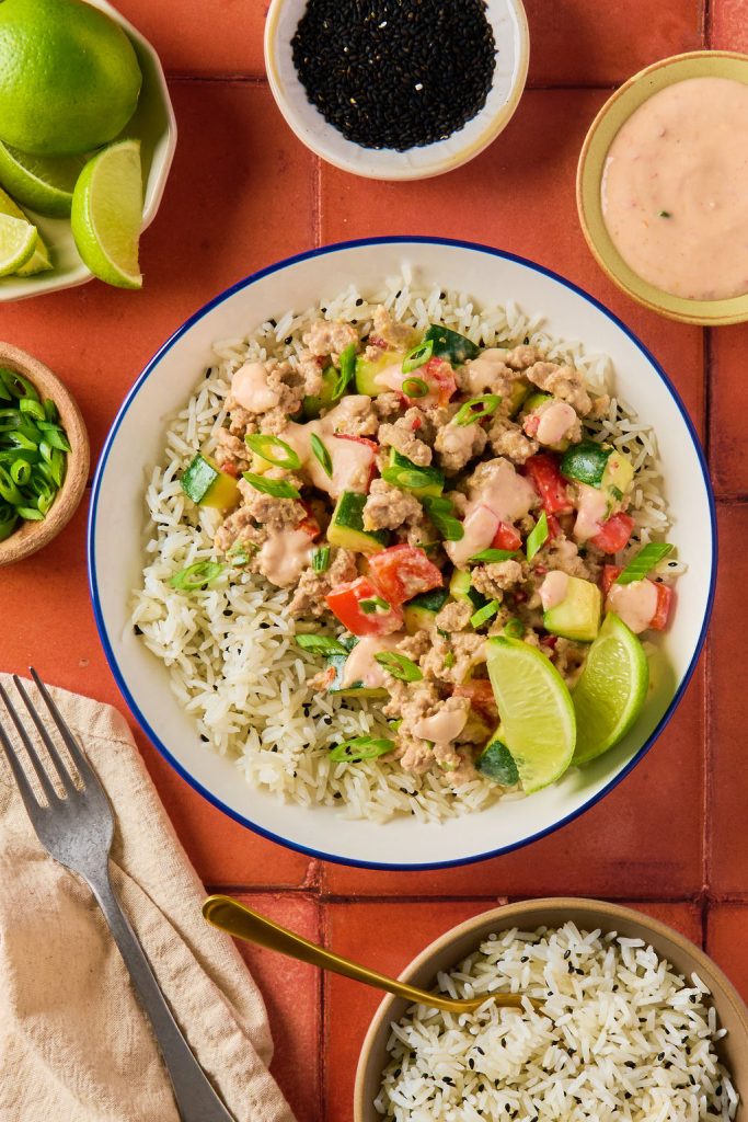 bang bang turkey over jasmine rice in a bowl