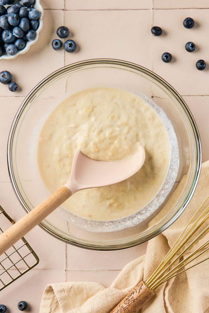 Greek yogurt, vanilla extract, and milk mixed together in a glass bowl