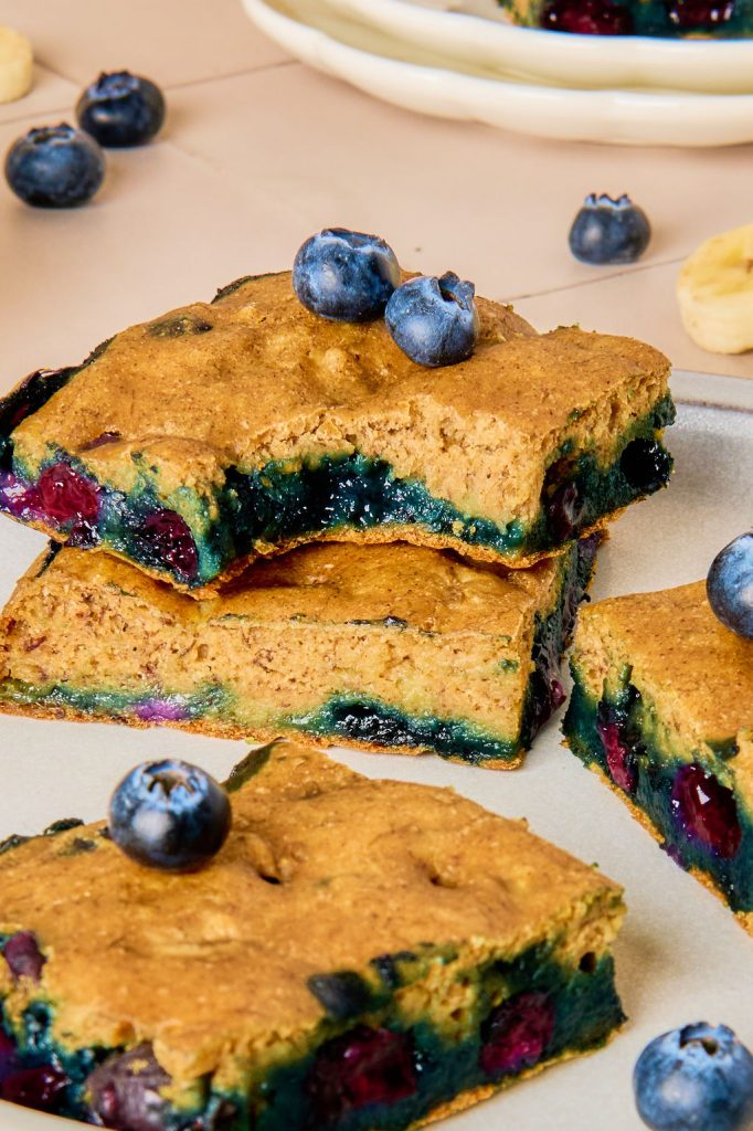 close up of blueberry banana oatmeal bars with a bite taken out of one bar