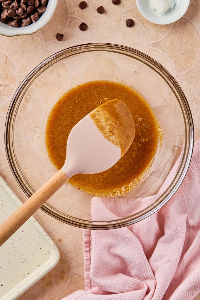 maple syrup, almond butter, and vanilla combined together in a glass bowl
