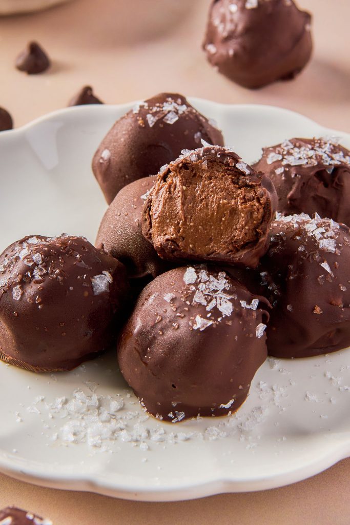 stack of truffles on a plate with a bite out of on, showing the inside