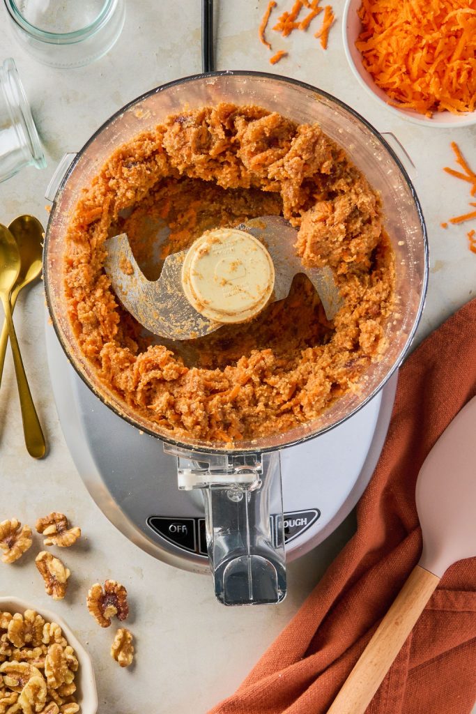 all the ingredients for the carrot cake base blended in the food processor