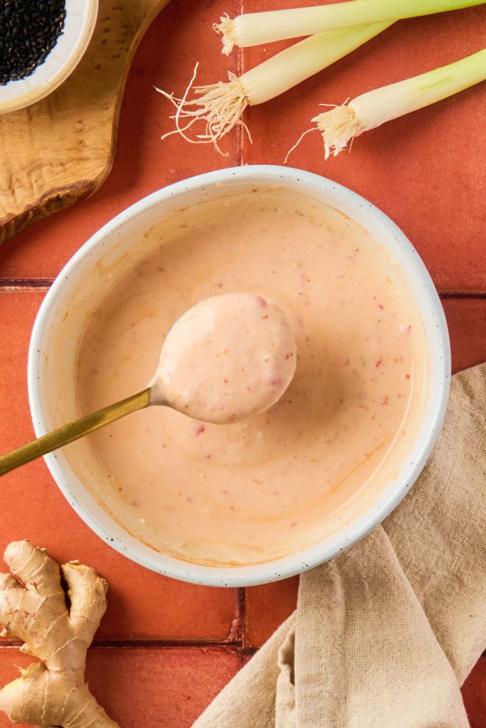 bang bang sauce mixed together in a white bowl with a spoon