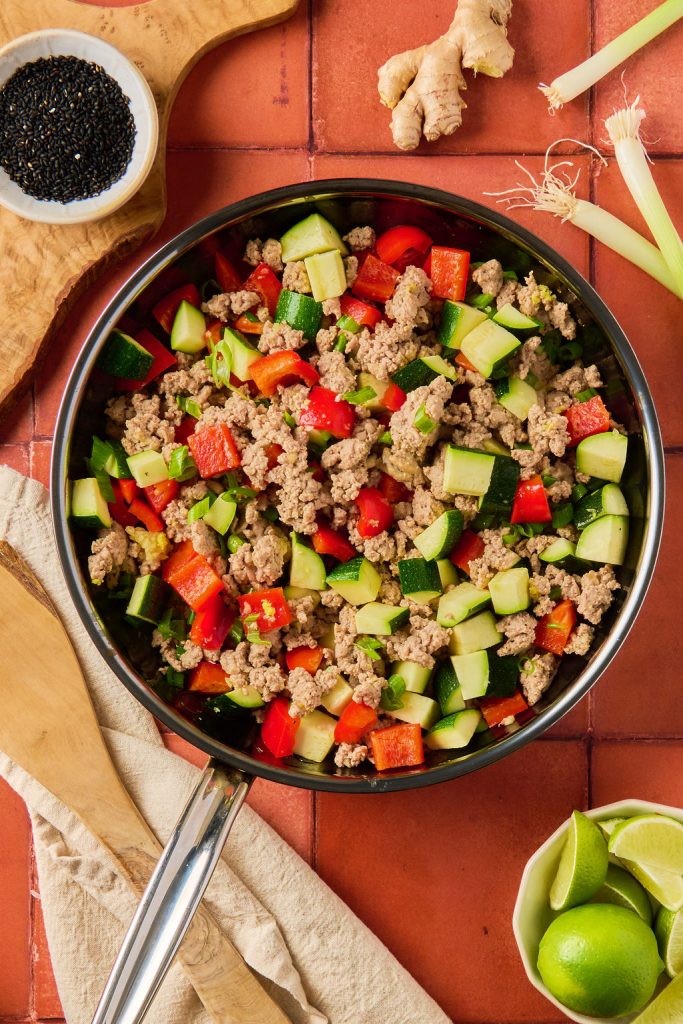 veggies cooking with ground turkey in a skillet