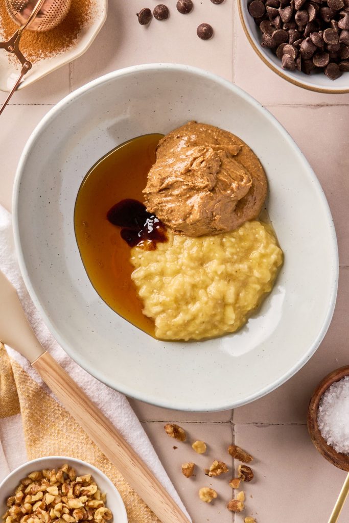 mashed banana, almond butter maple syrup and vanilla in a bowl