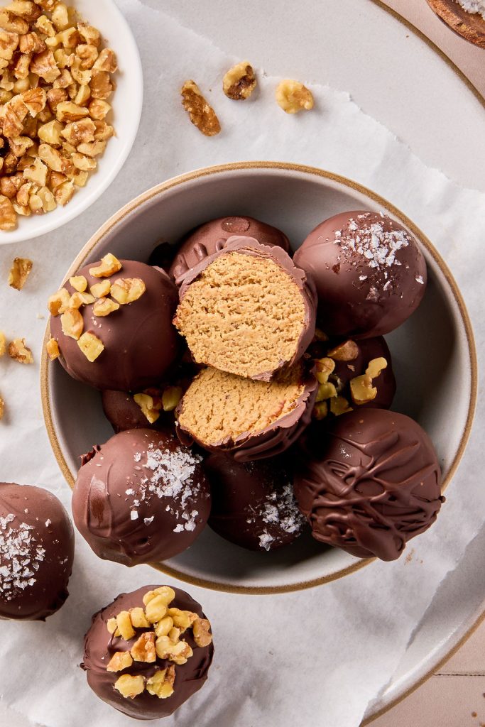 close up of banana bread bites in a bowl with a few cut open to see the inside texture
