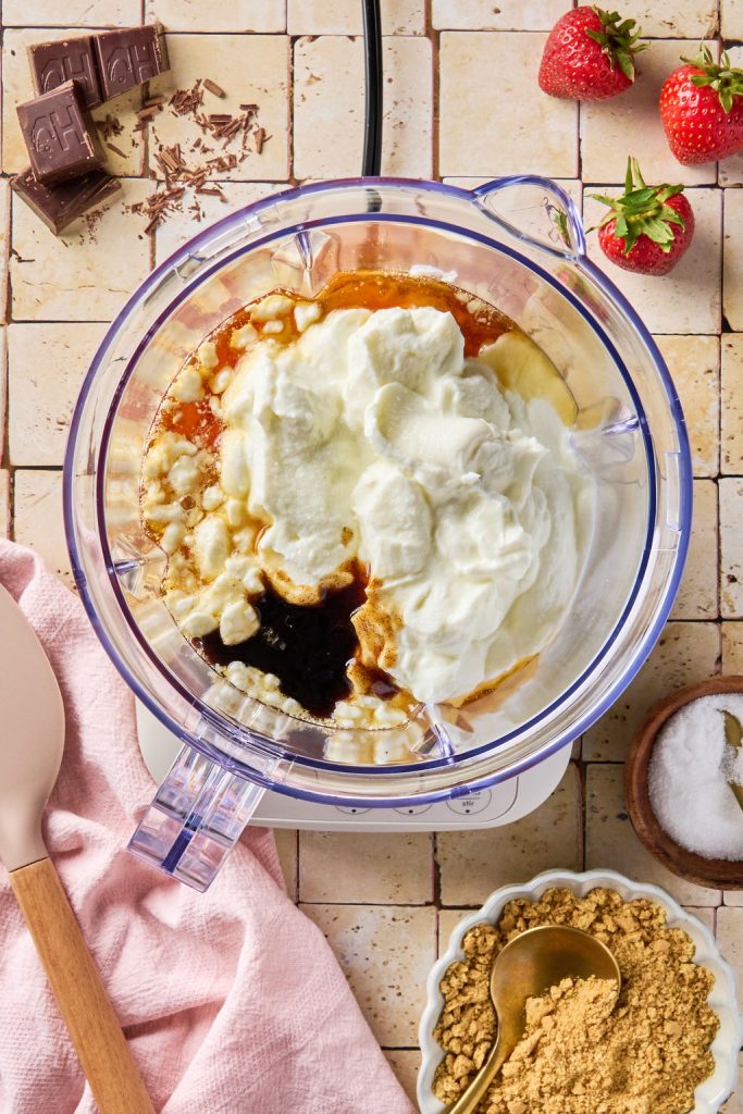cheesecake base ingredients added to a blender