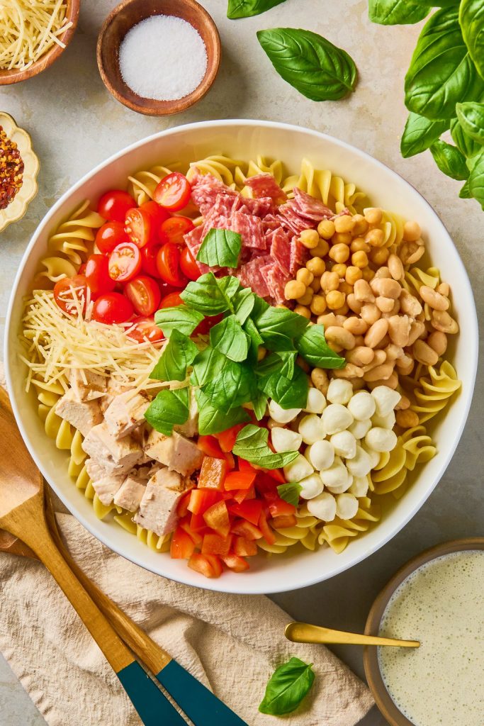 all the fresh ingredients added to the cooked pasta in a bowl