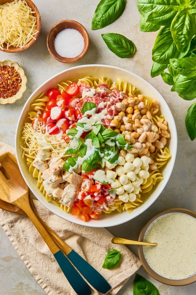 dressing drizzled over the pasta salad