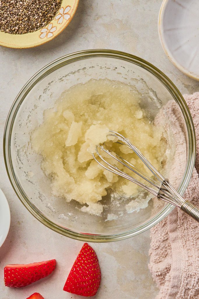gelatin and water mixed together in a glass bowl with a whisk until thickened
