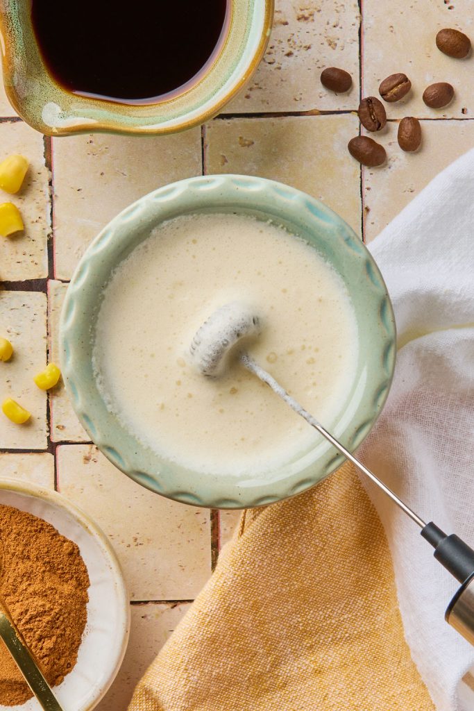 heavy cream, corn milk and maple syrup being whipped to make corn cold foam