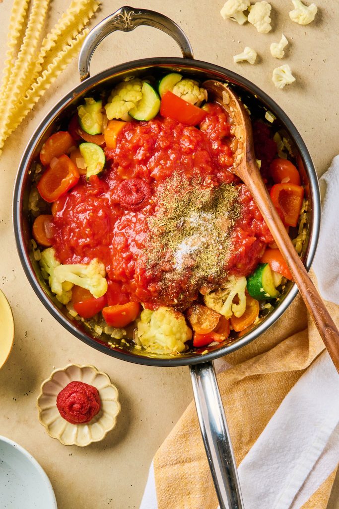 tomato paste and seasonings added to cooked veggies