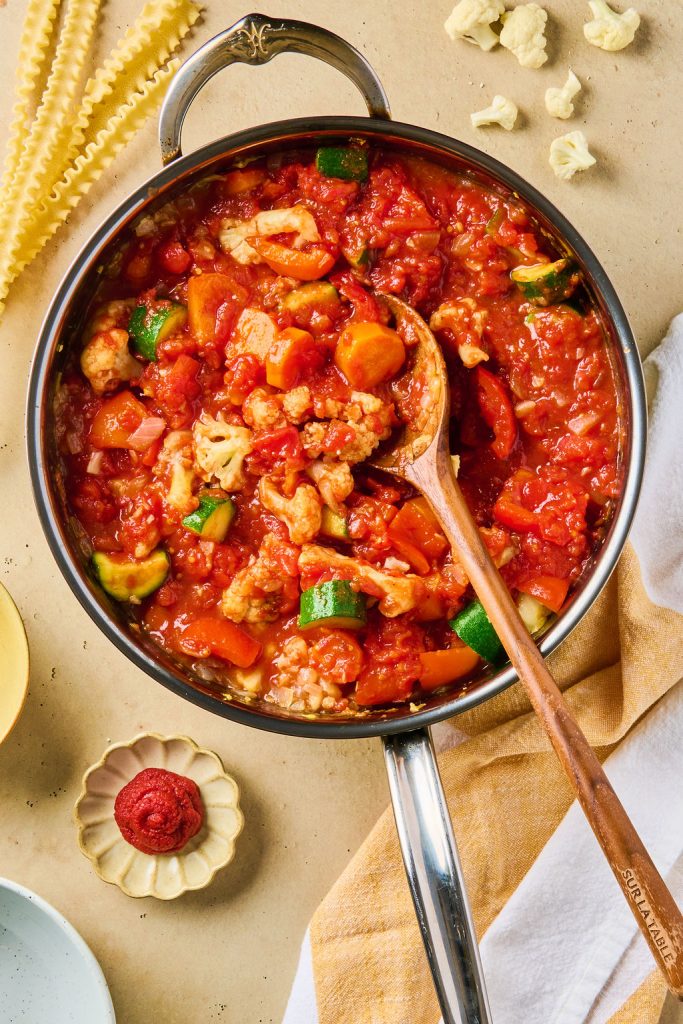 tomato paste and seasonings mixed into cooked veggies