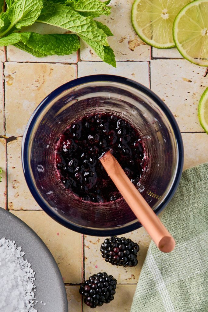 blackberries and agave nectar muddled in a glass