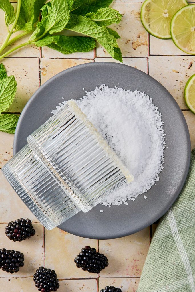 salt rim glass being added to margarita glass