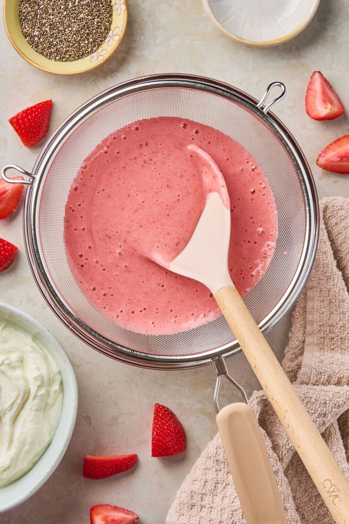blended strawberry mixture poured through a mesh sieve