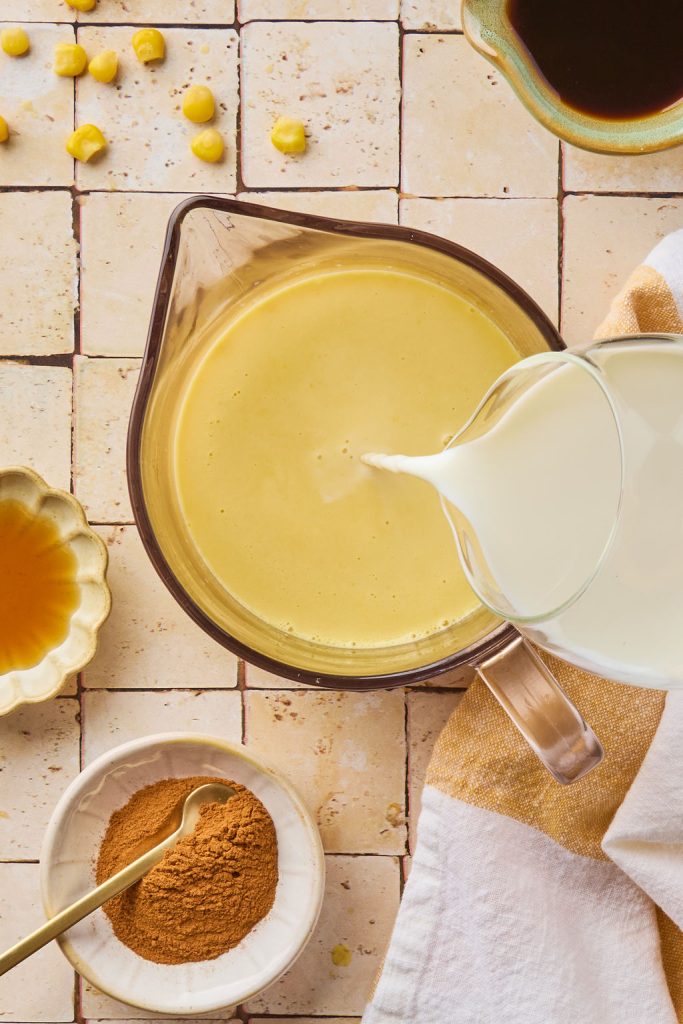 milk being poured into the corn mixture