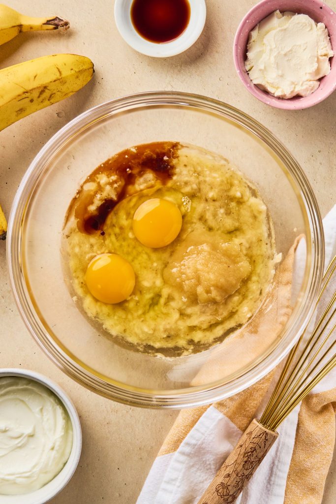 eggs, applesauce, oil and vanilla added to the bananas