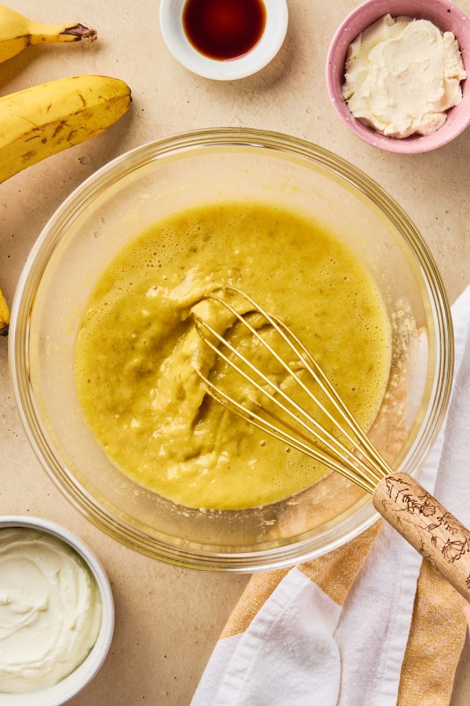 all the wet ingredients mixed up together in a bowl with a whisk