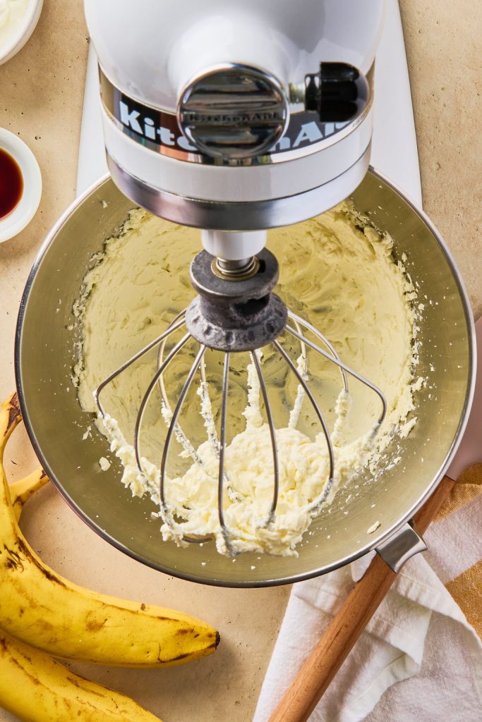 cream cheese being beat in a stand mixer