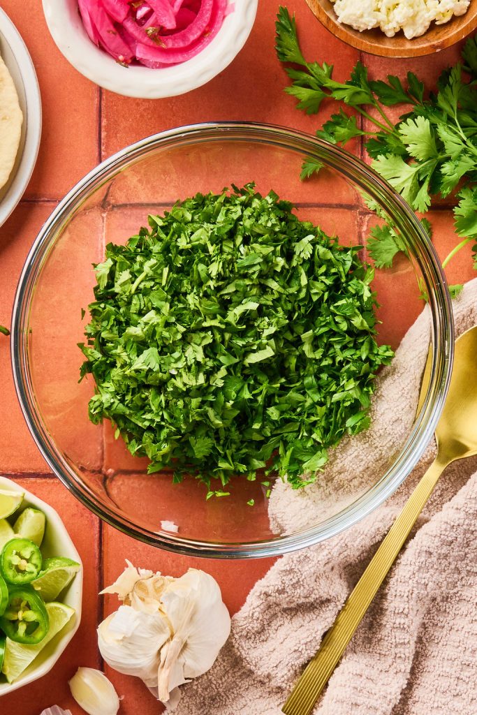 chimichurri herbs chopped in a glass bowl
