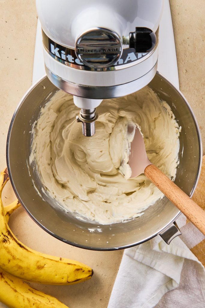 frosting in the stand mixer with a spatula