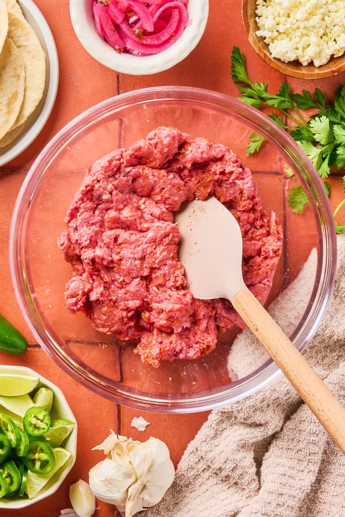 ground beef mixed with spiced in a bowl