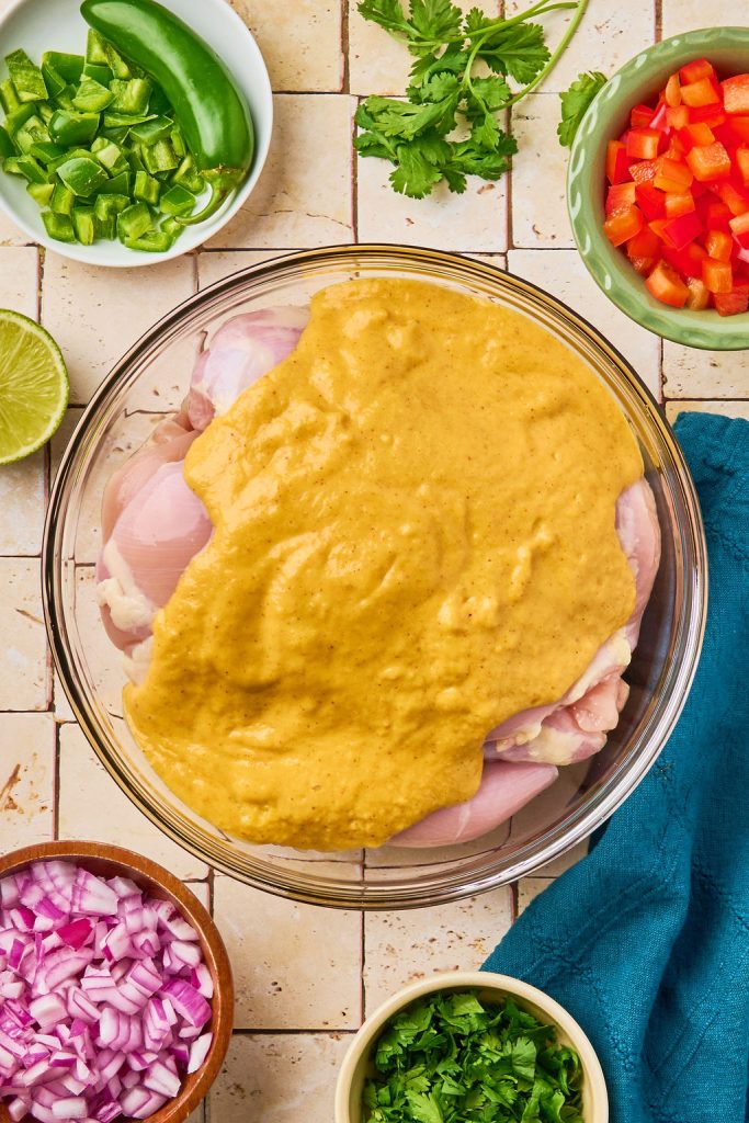 marinade added to the chicken in a bowl
