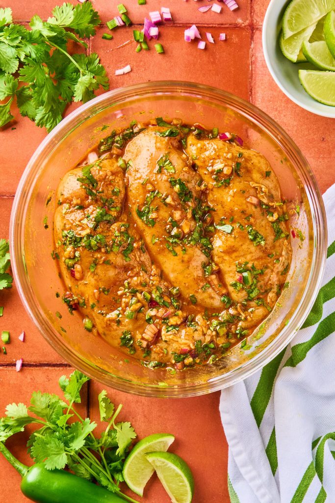 cilantro lime marinated chicken breasts in a glass bowl