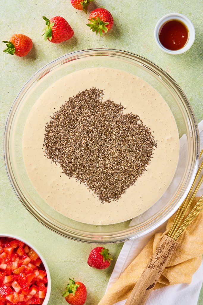 chia seeds added to pudding mixture in a bowl