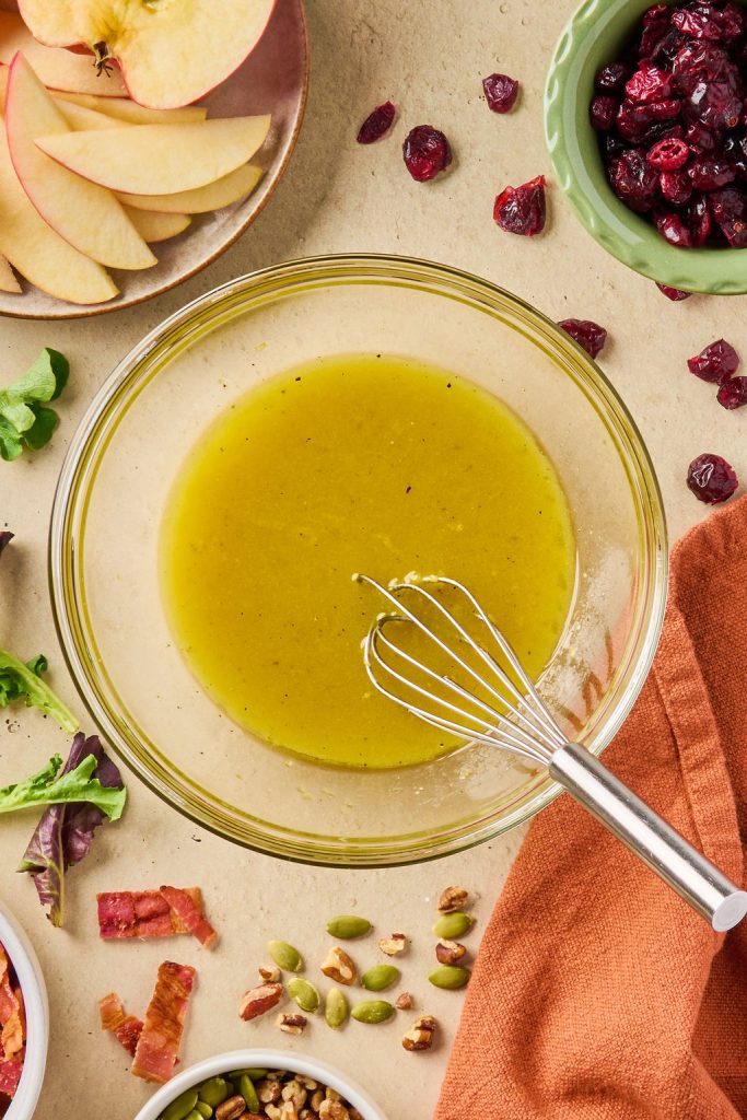 maple dijon dressing all whisked together in a glass bowl